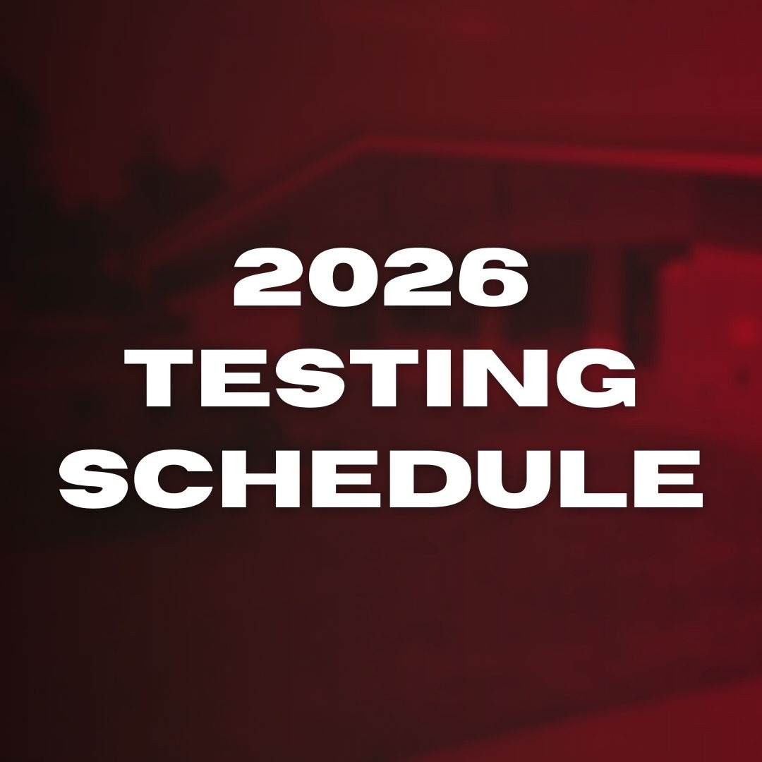 White text on a red background reads "2026 Testing Schedule". A blurry image of a building is in the background.