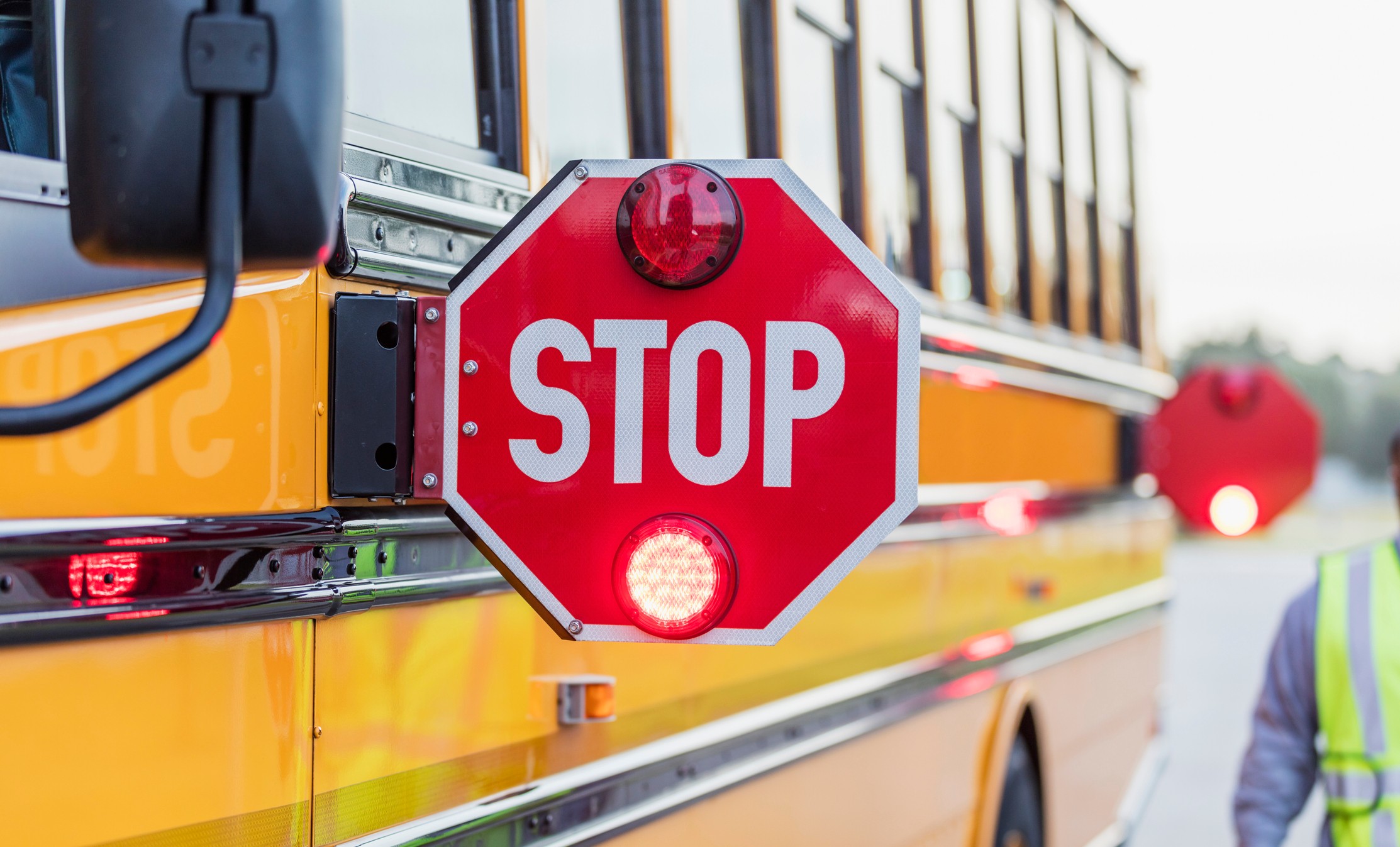 School bus with stop sign blinking