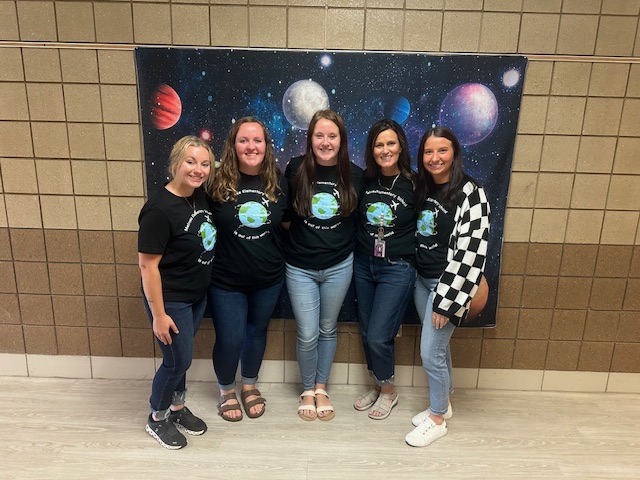 5 women in front of planets on a backdrop