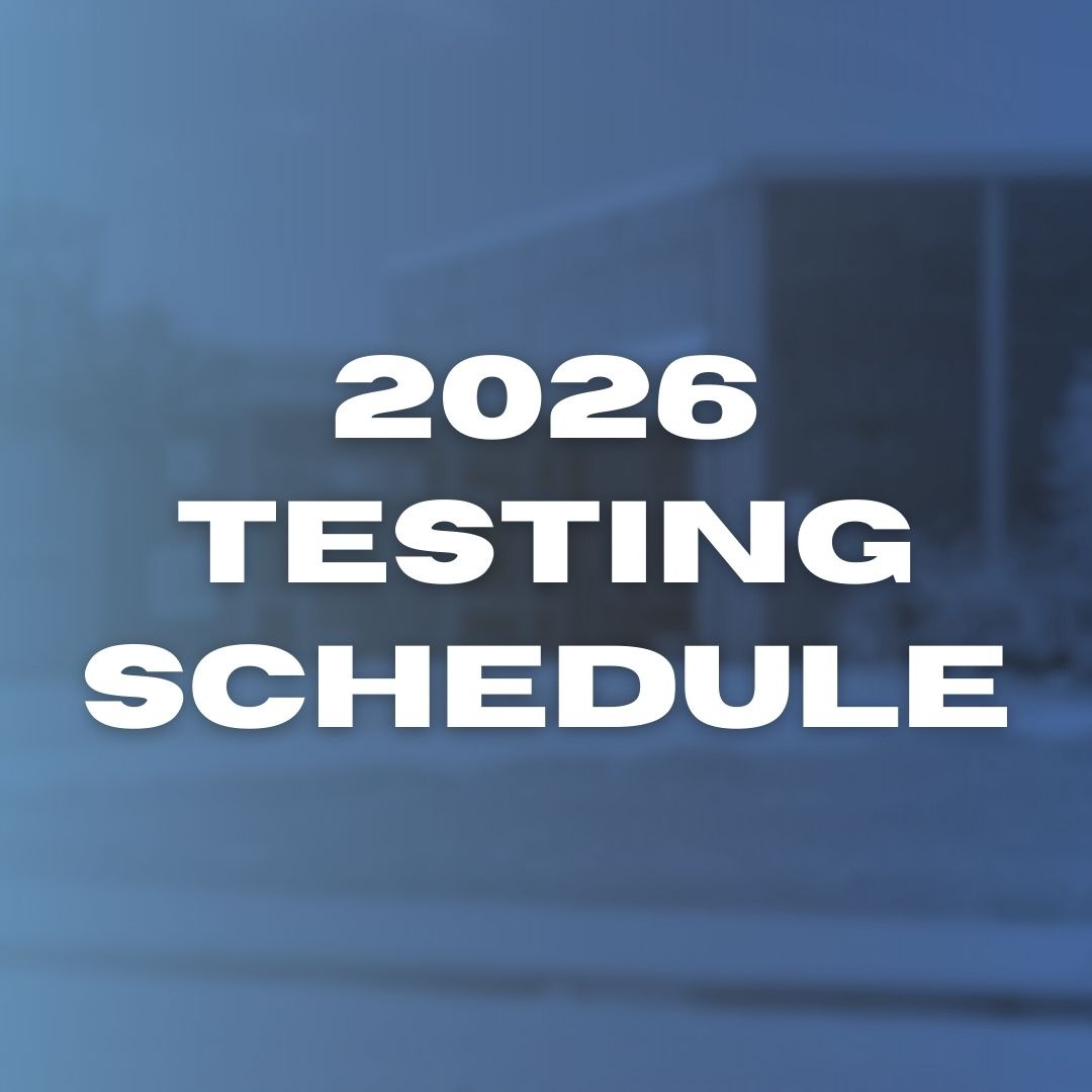 A blue backdrop displays bold, white text: "2026 Testing Schedule". Behind the text, a blurred view of a building.