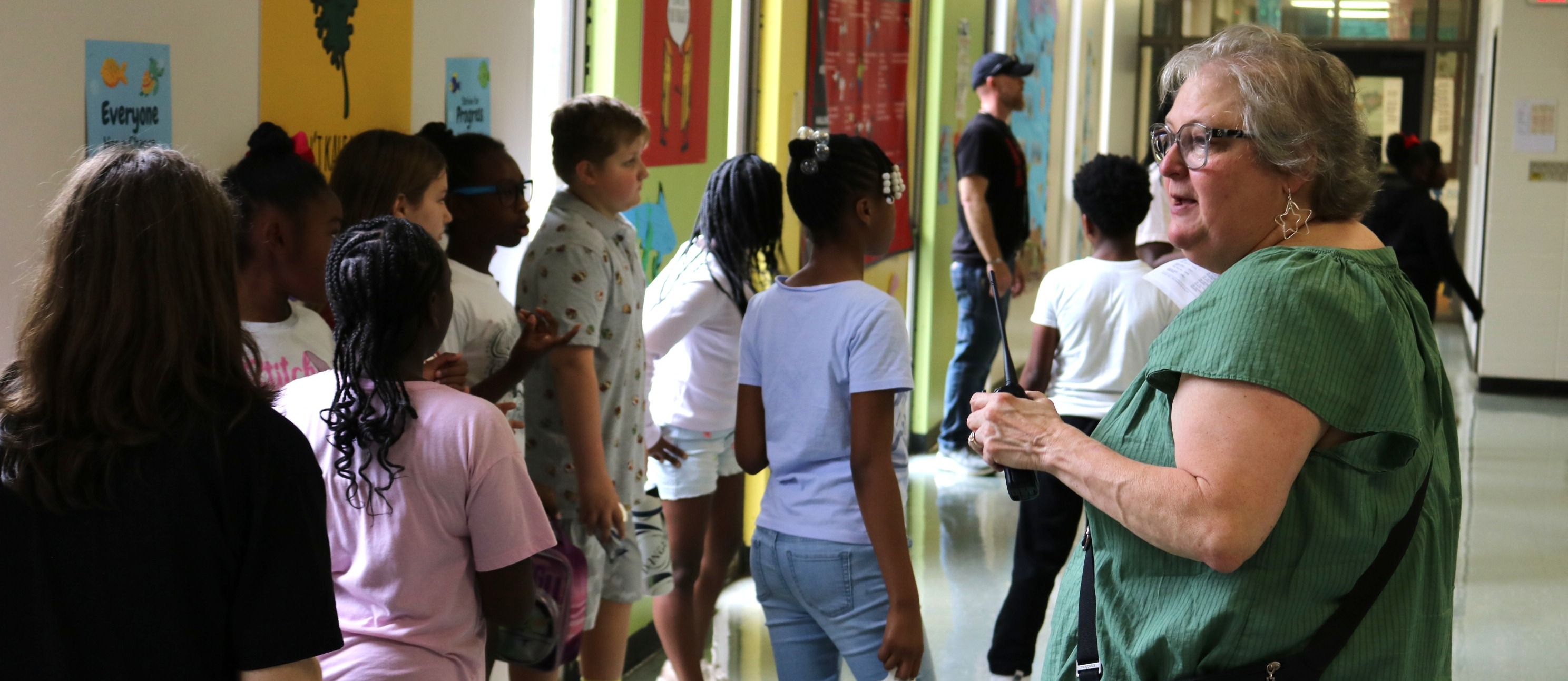 Principal Staisey Hodge in a cafeteria instructing students