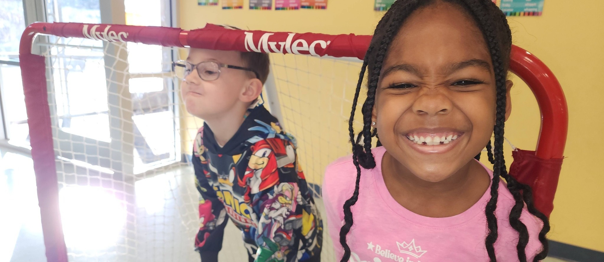 Pine Forest March slider of two students by a soccer goal