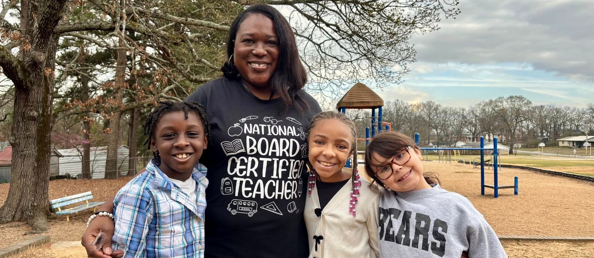 A teacher smiling with her students