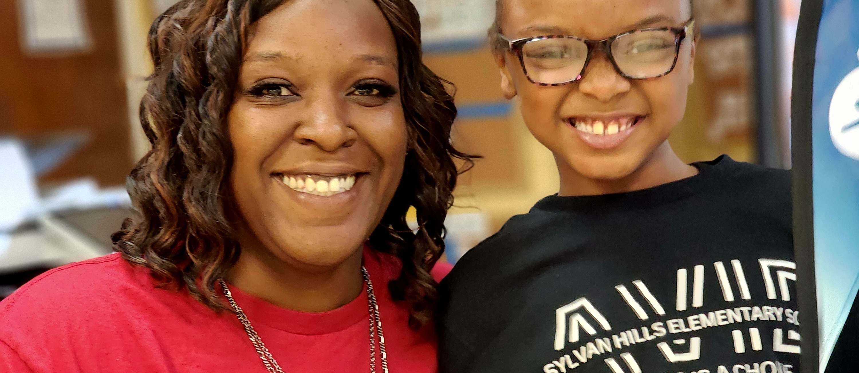 Principal Britney Hickman and a student in AVID gear smiling