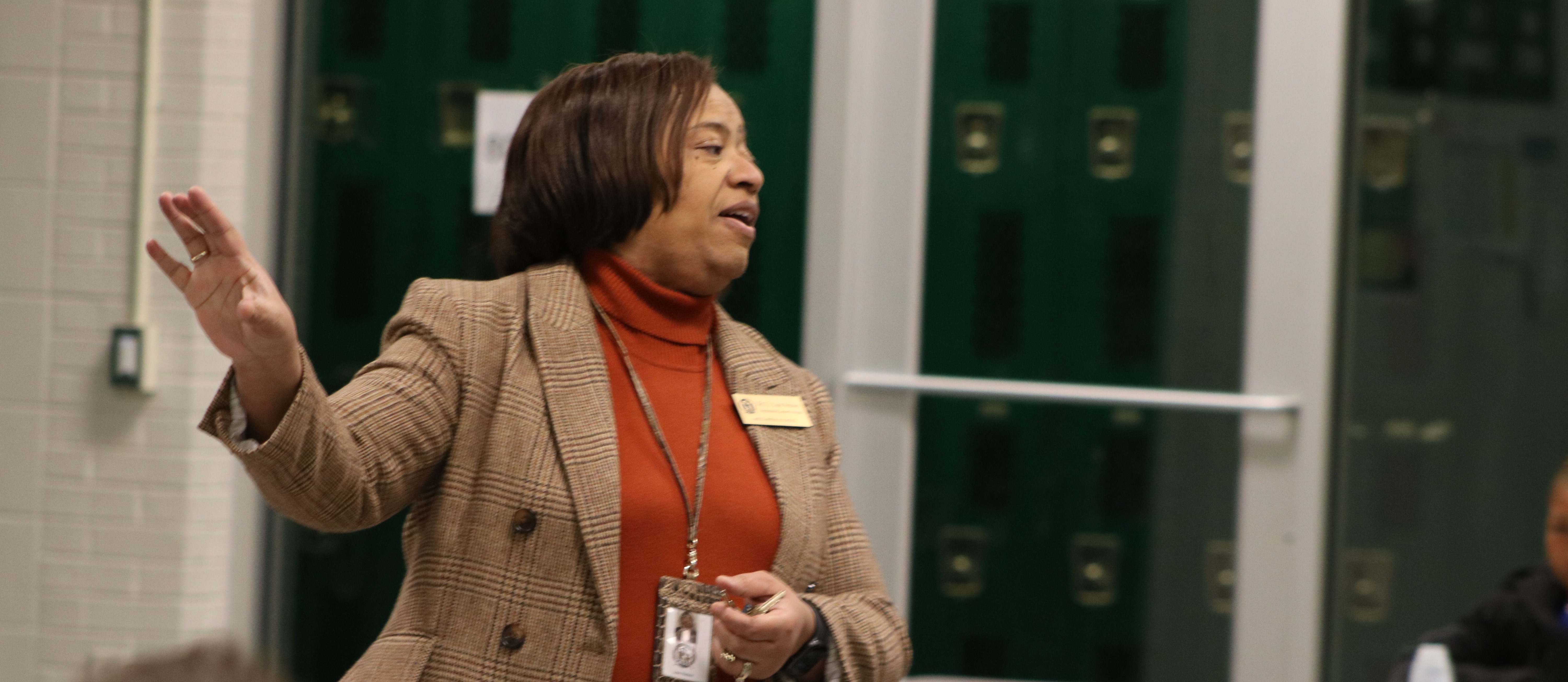 Dr. Lisa Watson speaking to a crowd in the Mills Middle cafeteria