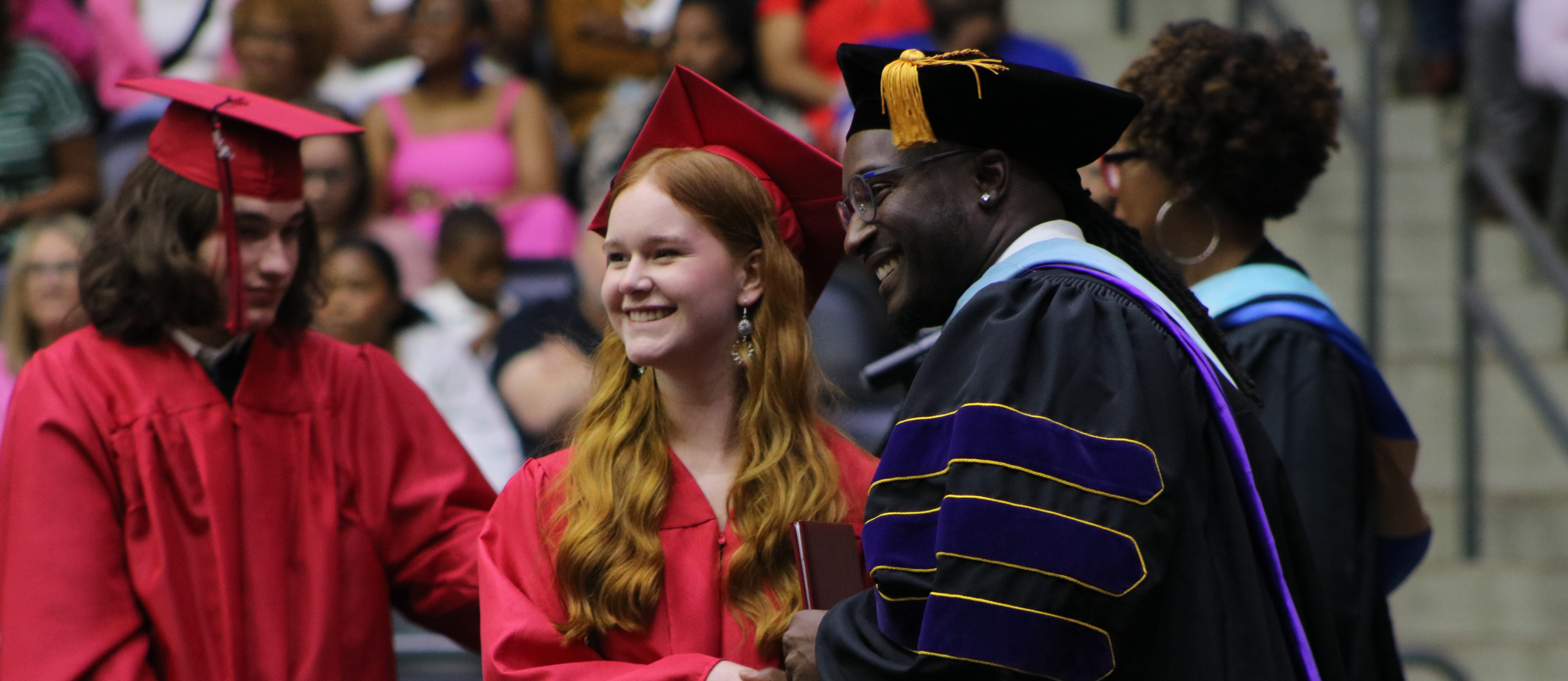 A graduate receiving a handshake from Dr. Nick Farr, principal of Maumelle High School