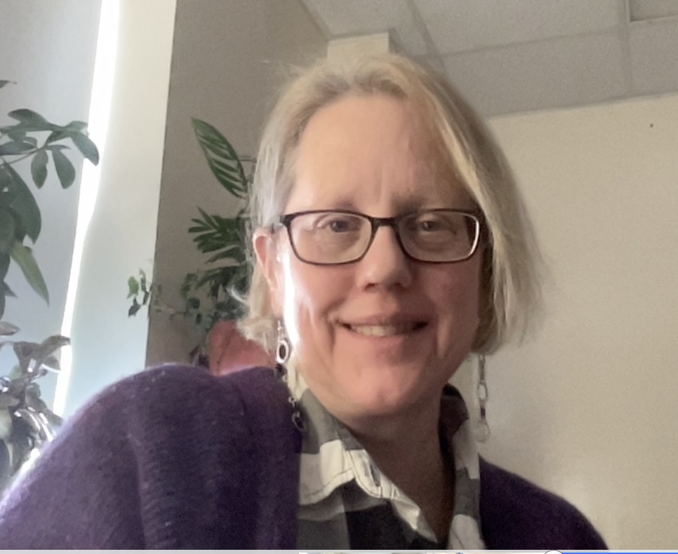 Ellen Bailey headshot in a purple shirt