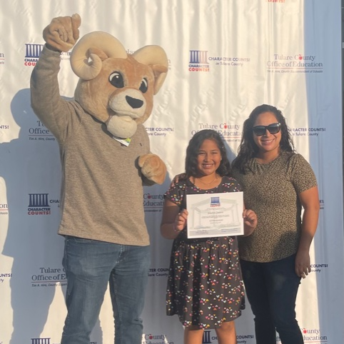 Ram celebrates with student and her parent