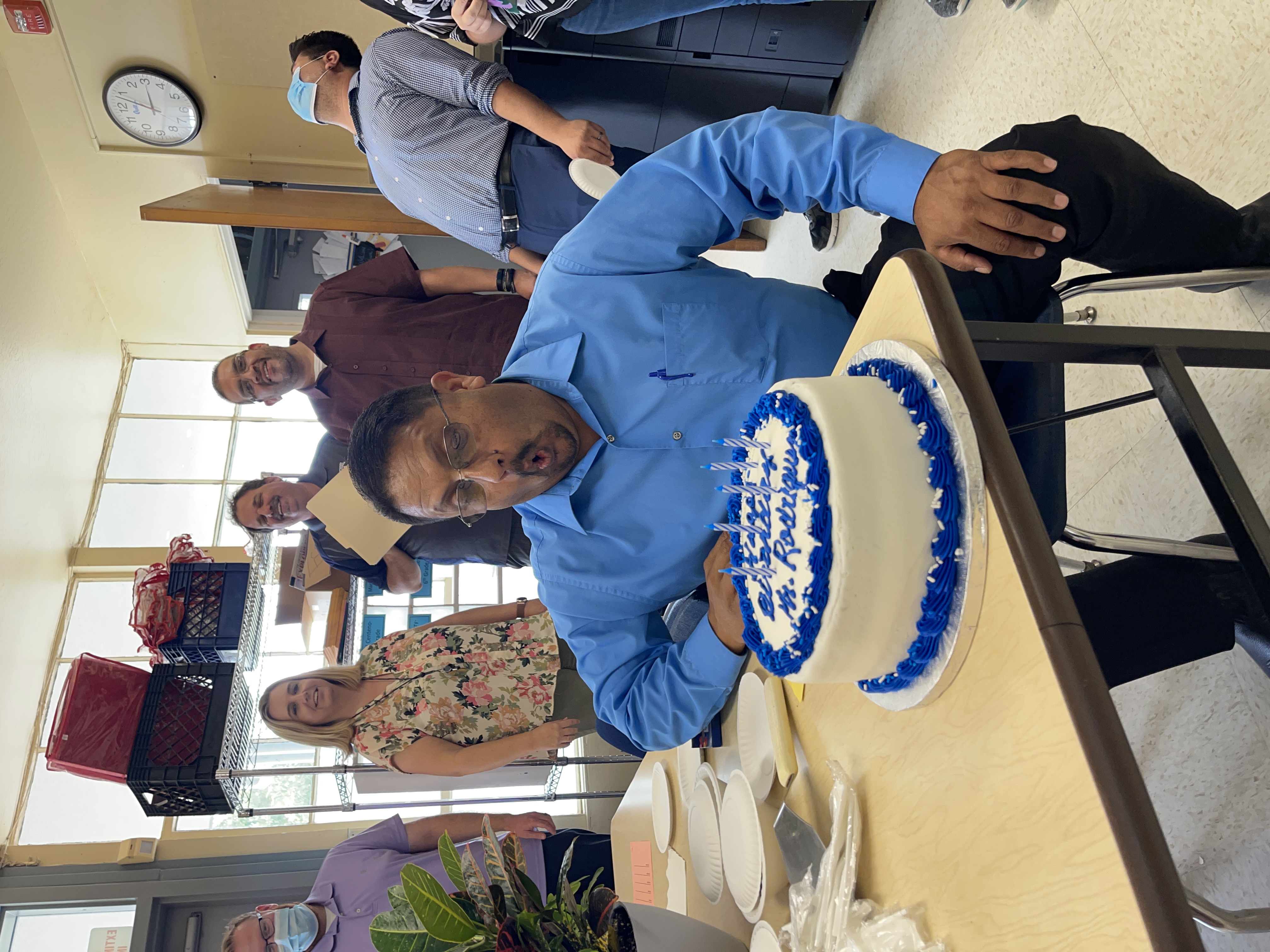 Mr. Isidro celebrates his birthday and blows out the candles on his cake.