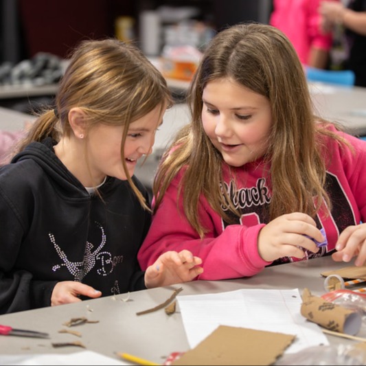 Students at a table smiling