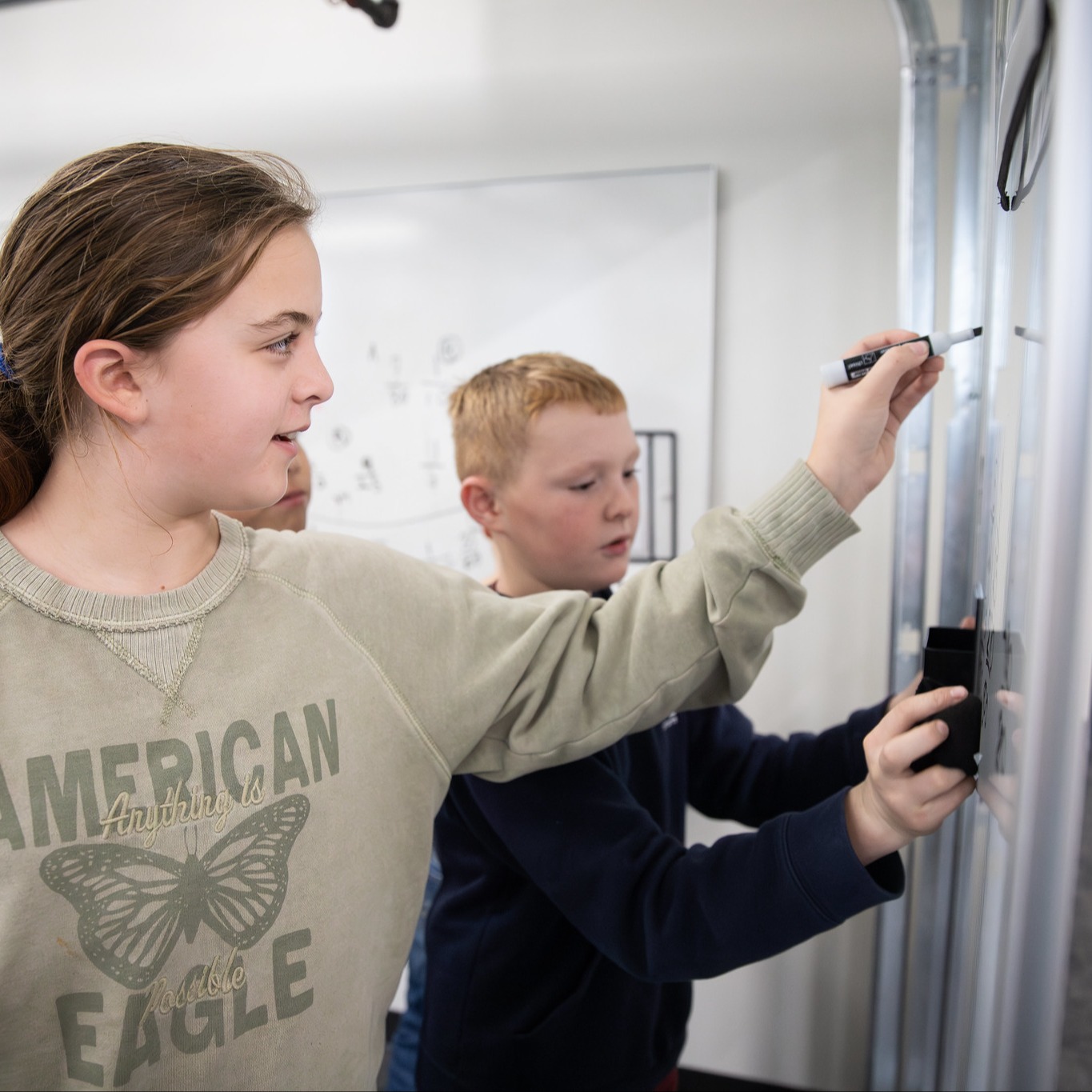 Students writing on the board