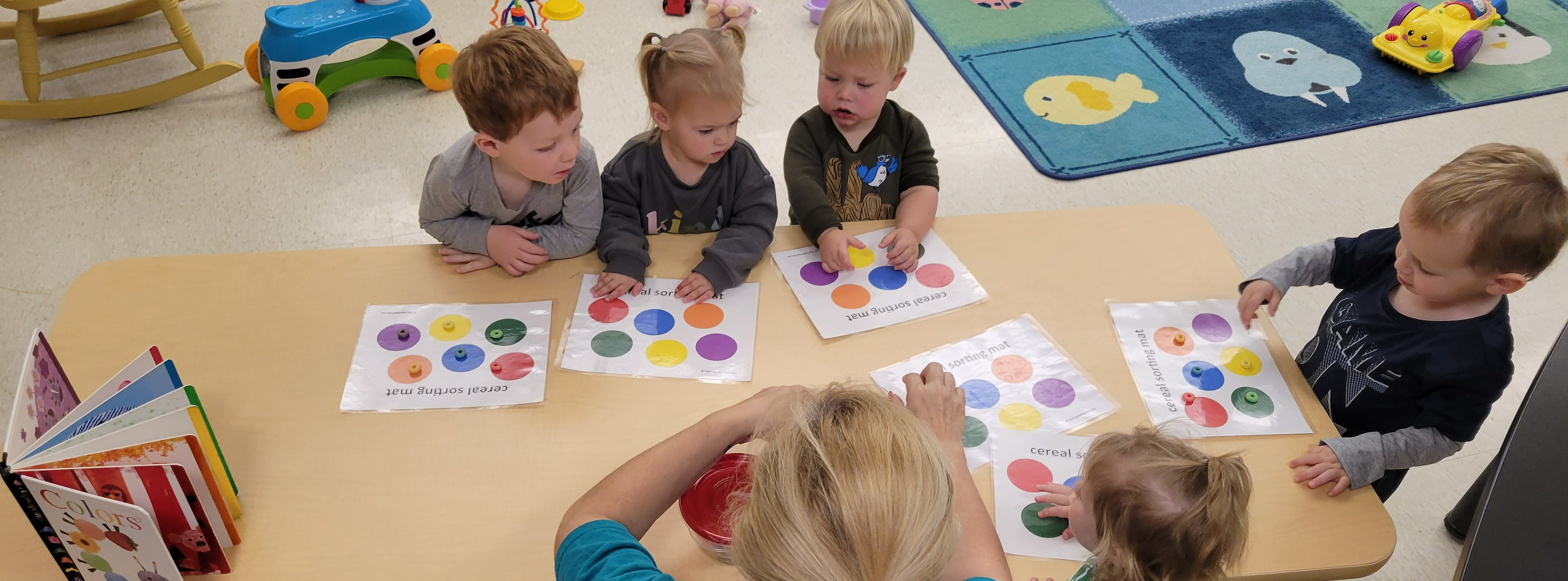 The toddlers are working hard on their colors.