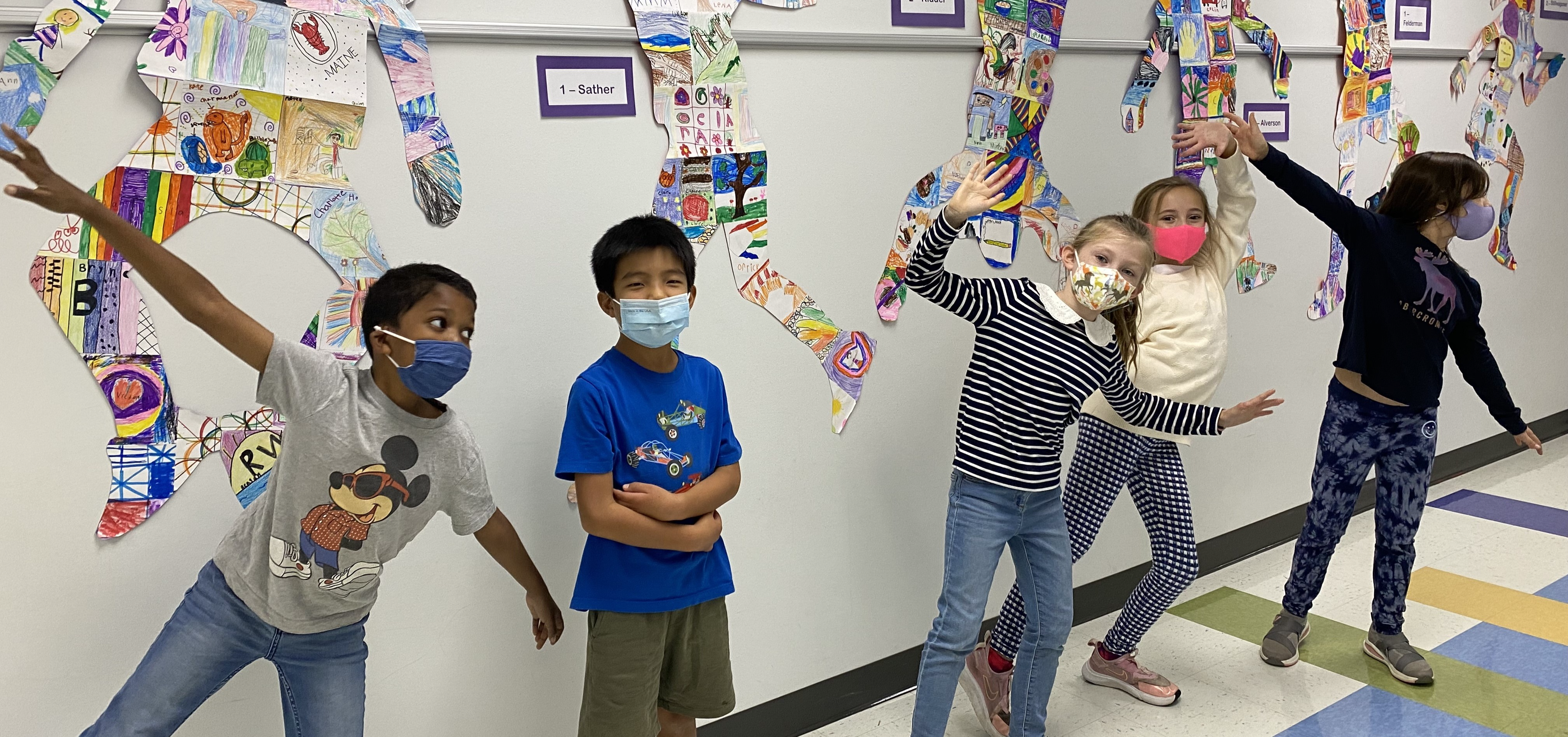 Students posing in front of their artistic images.