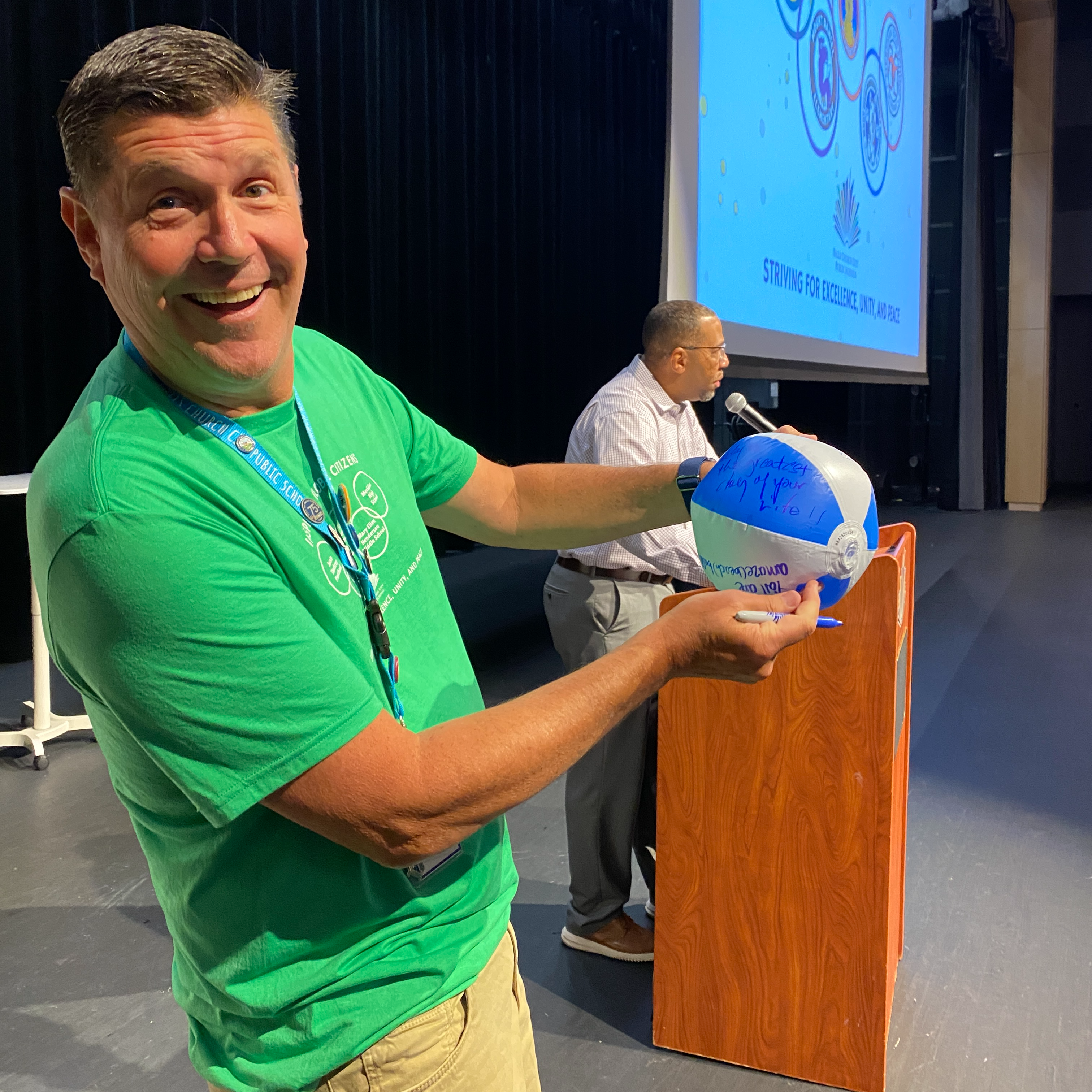 Dr. Noonan on stage with beachball