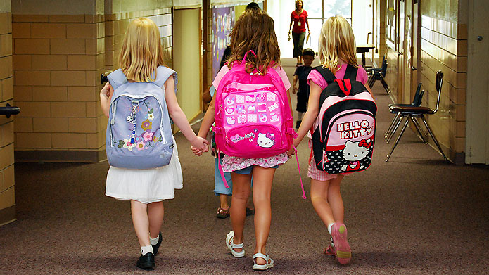 Three girls walking together to school