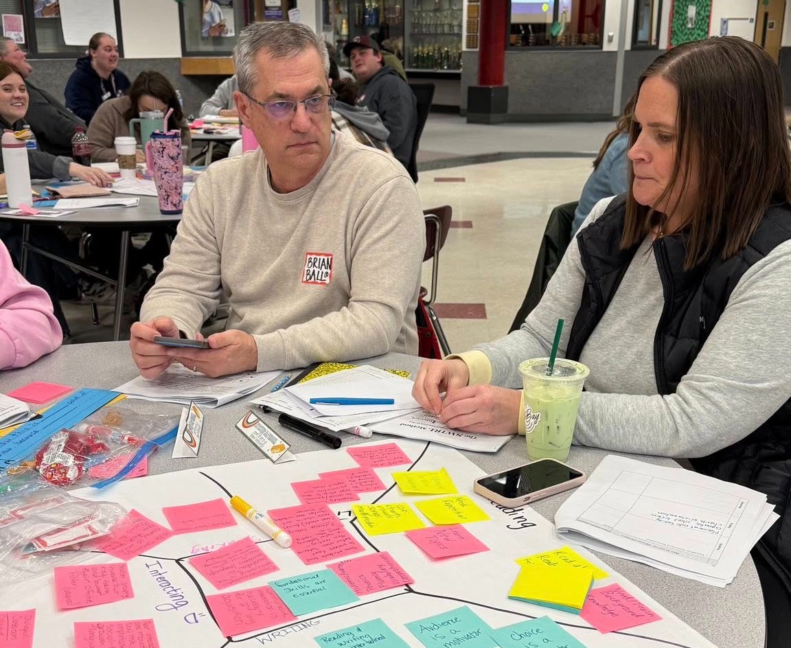 Kids raising hands in class