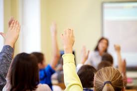 Kids raising hands in class