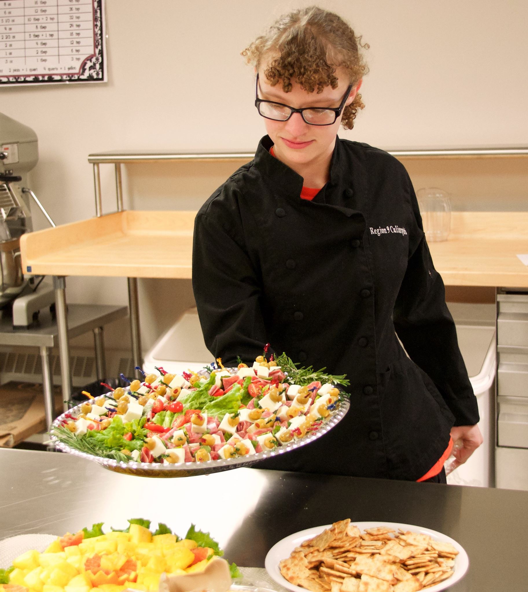 Student displays beautiful tray of appetizers