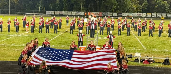 Westby Band half time show at a football game displaying the american flag