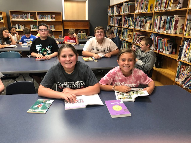 Fifth graders spend time in the library.