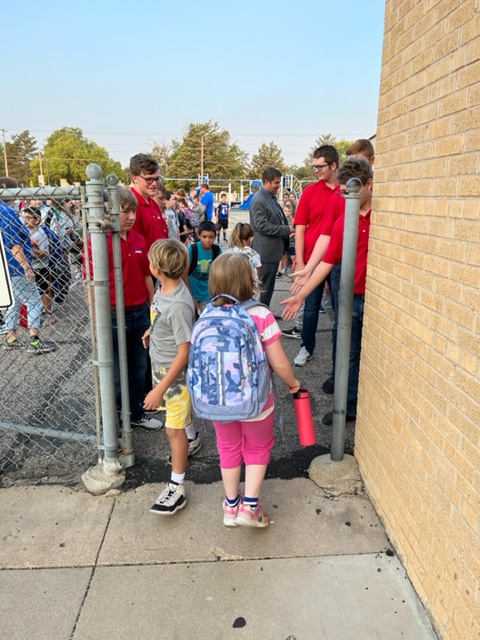 The high school football team welcomes the BES students to school.