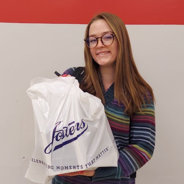 Senior Laney holding a bag while smiling