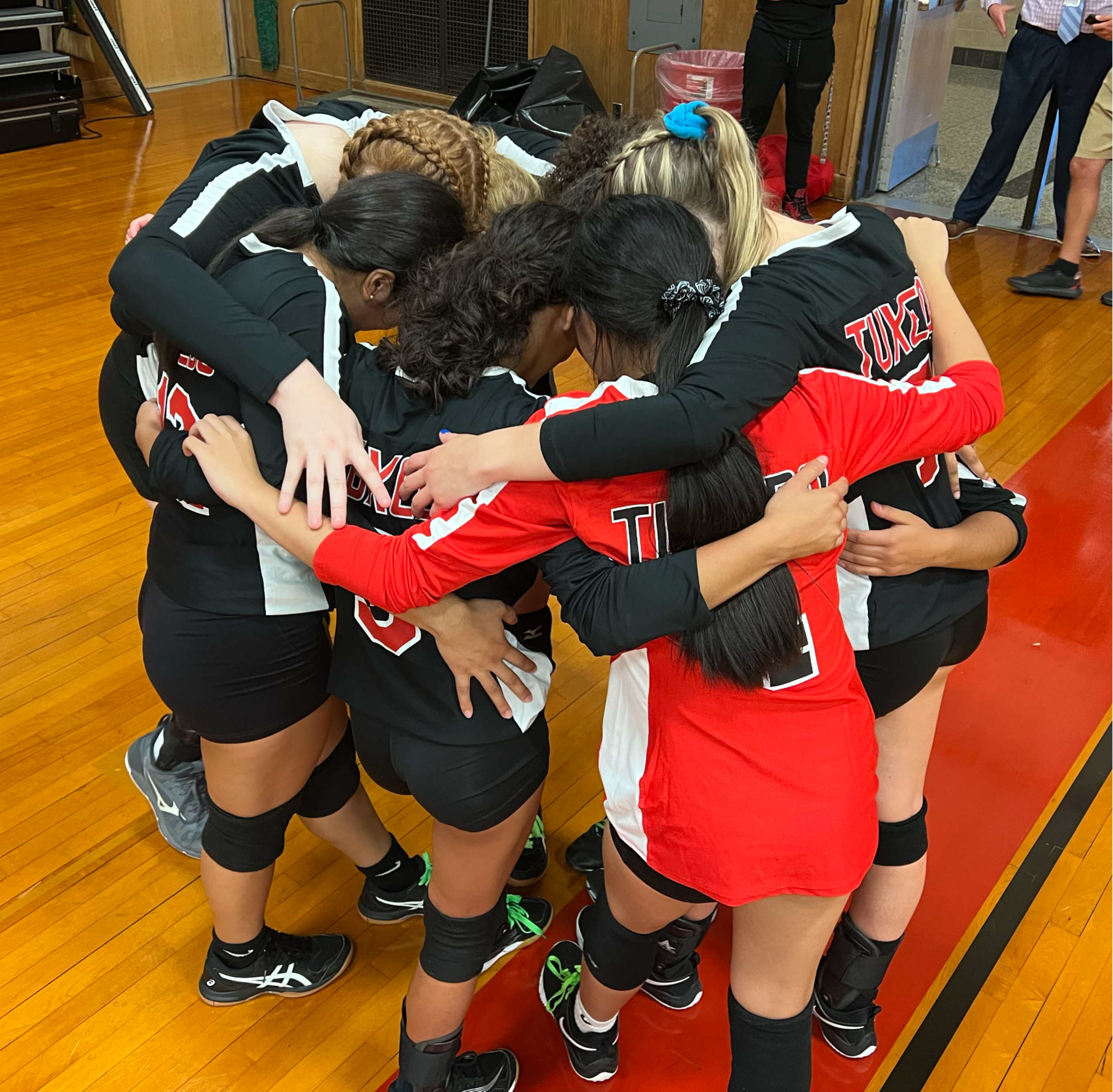 Volleyball players in huddle before game