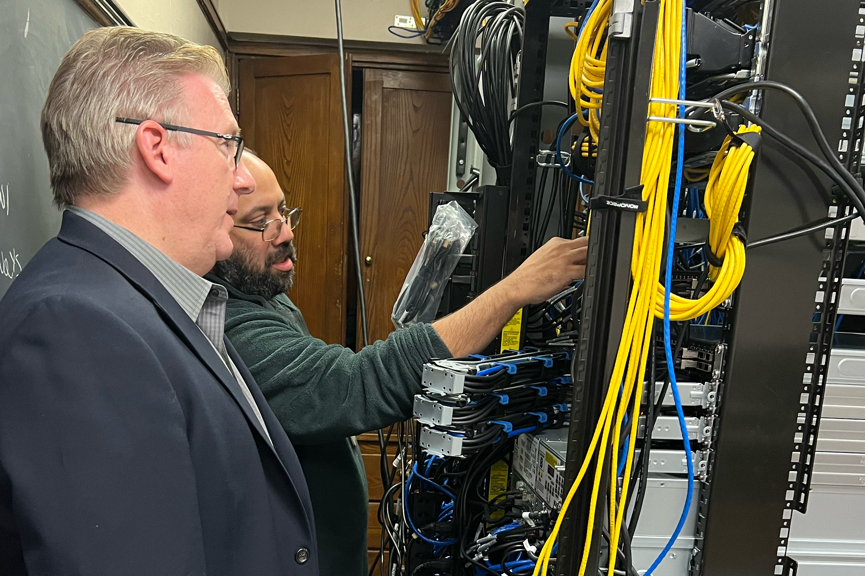 Superintendent White looking at new computer server