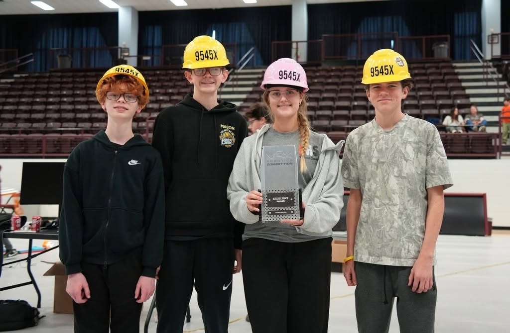 4 students with hard hats on holding an award