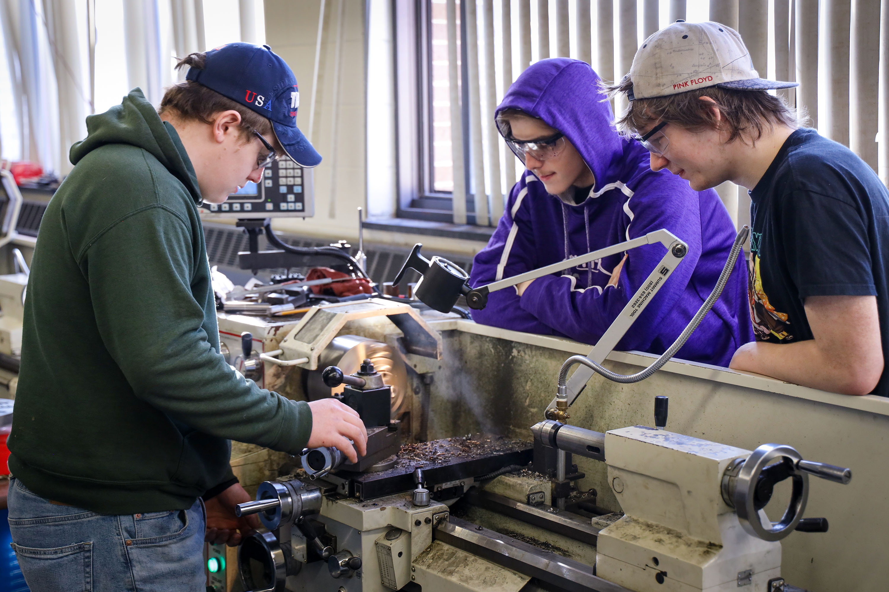Three students using machinery in Advanced Manufacturing