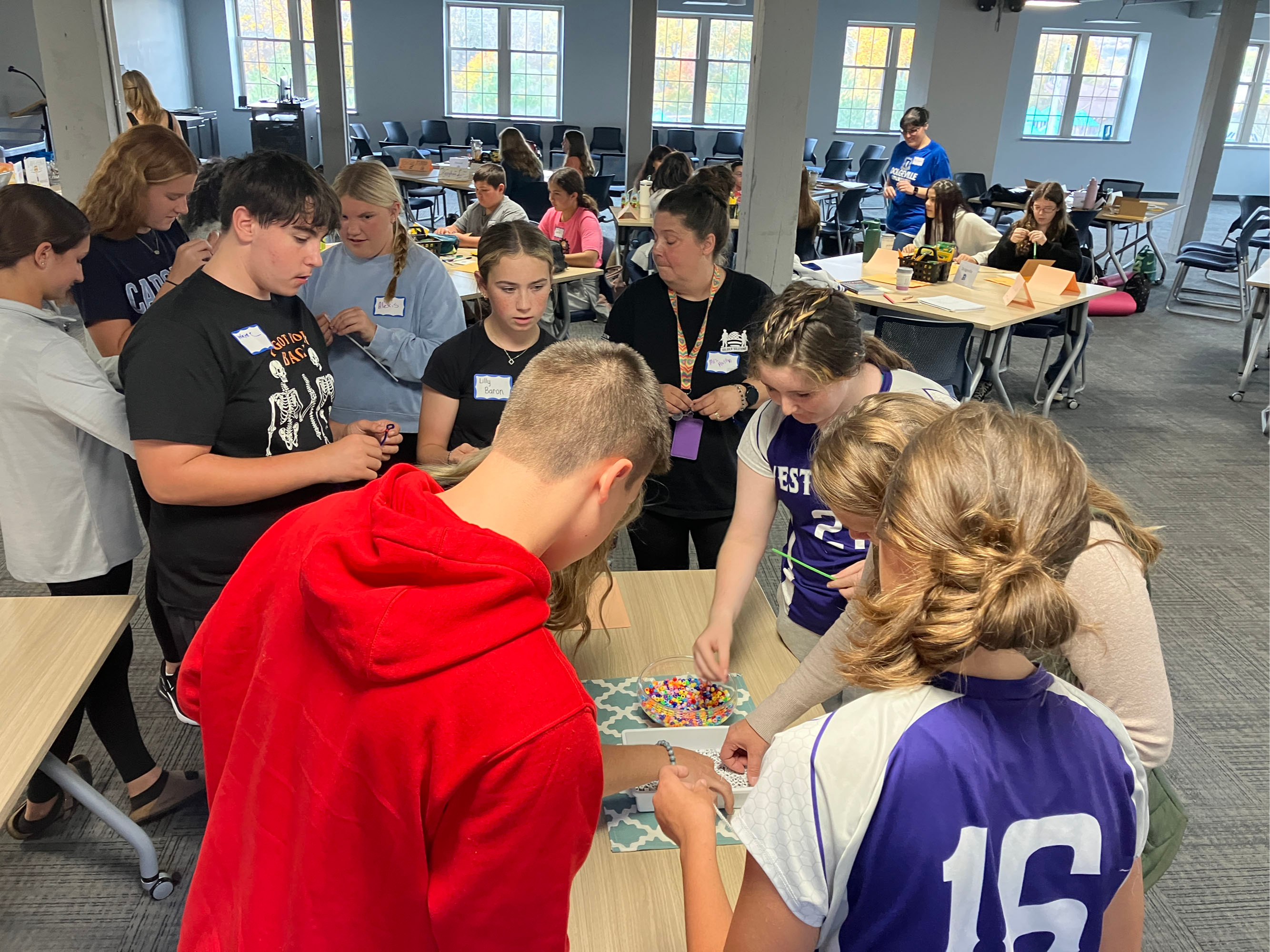 Honors Program students participating in an activity making bead bracelets 