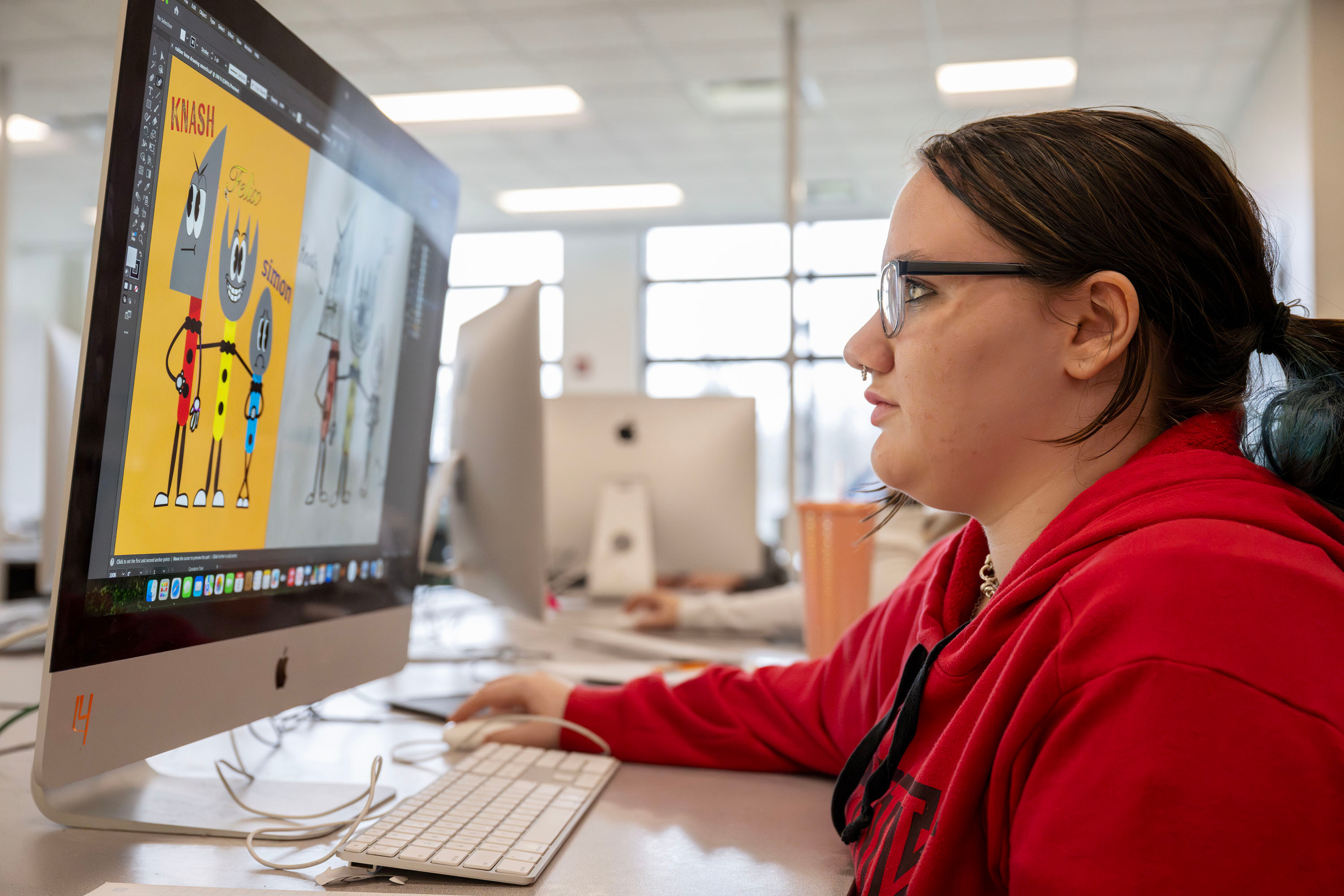 Visual Communications Media Arts student working on a design on computer