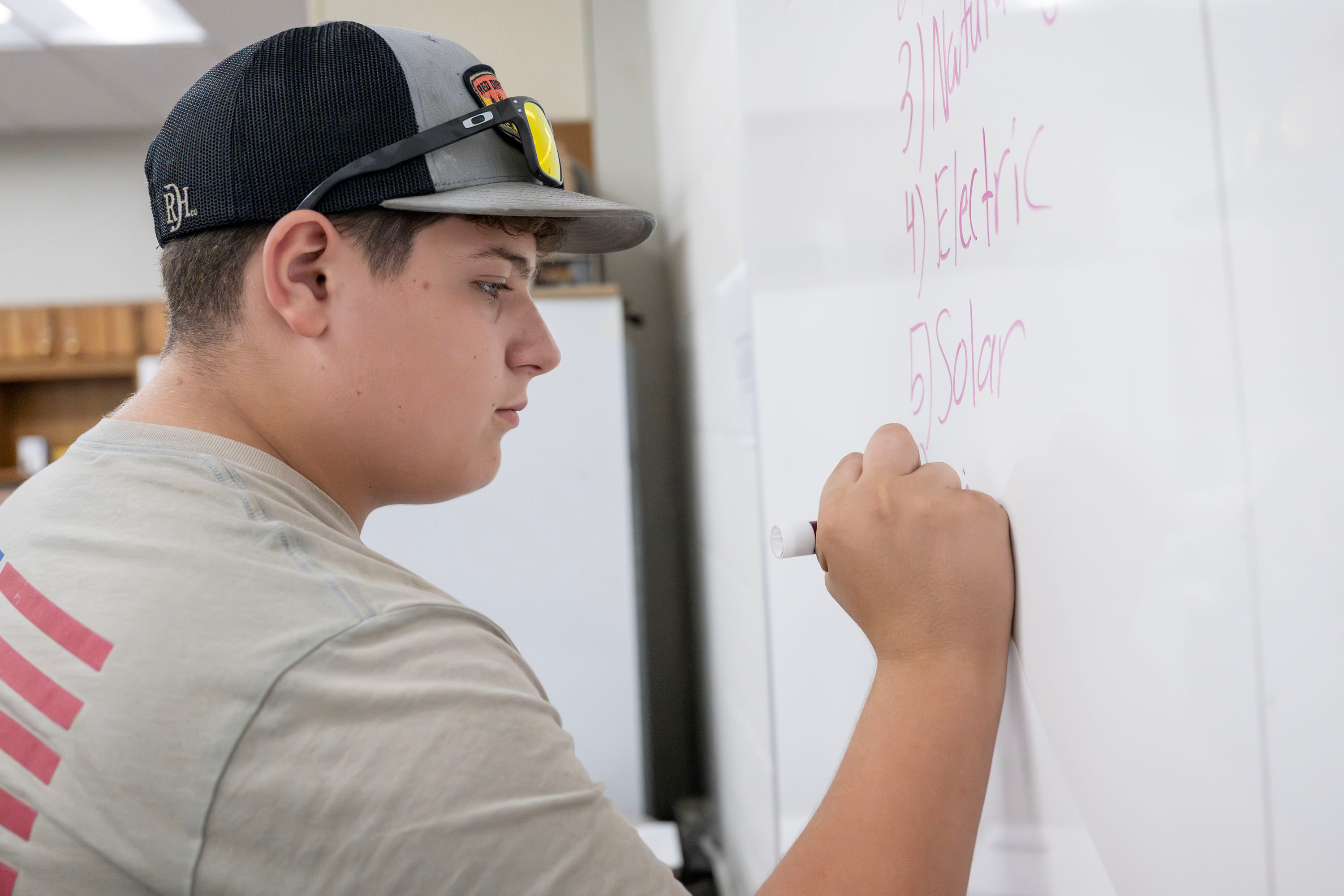 READiTEC student writing on a dry erase board