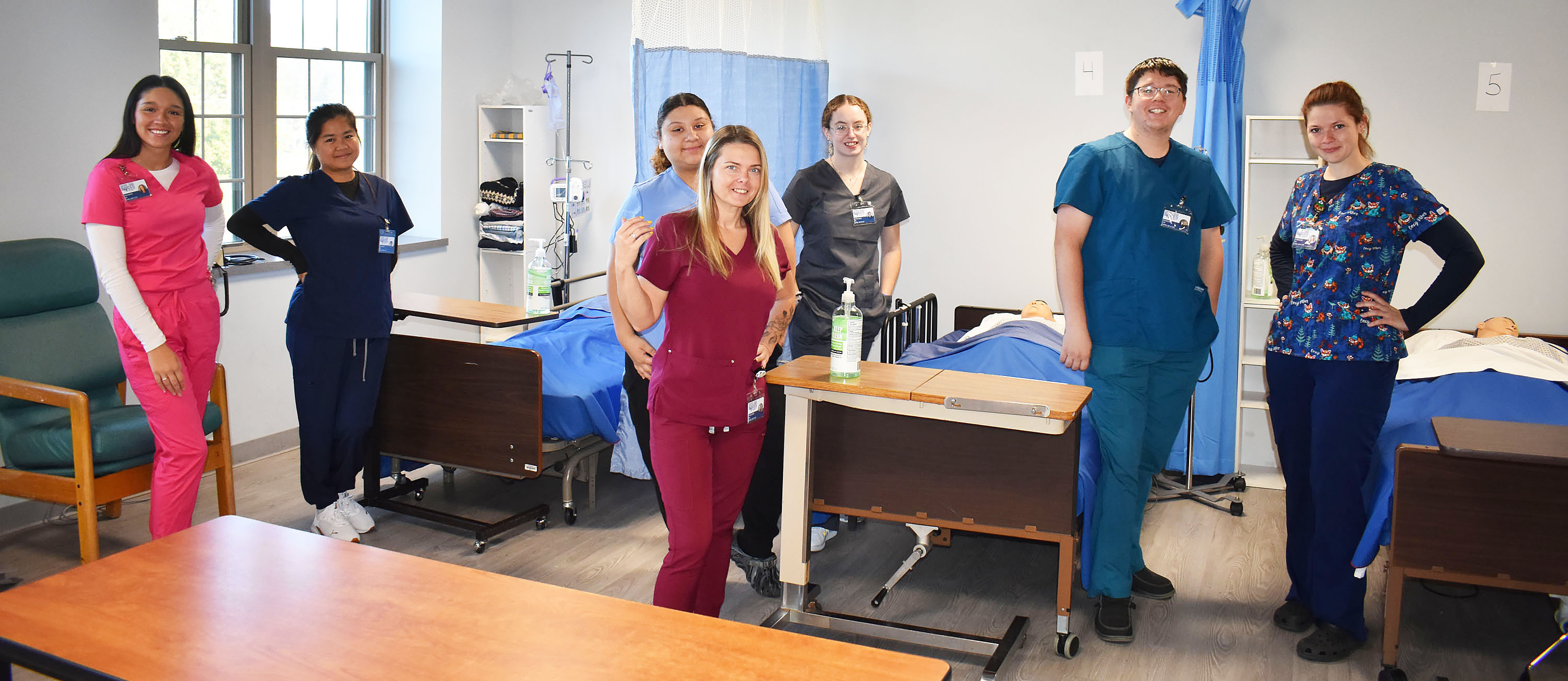 Adult LPN students posing together in a lab