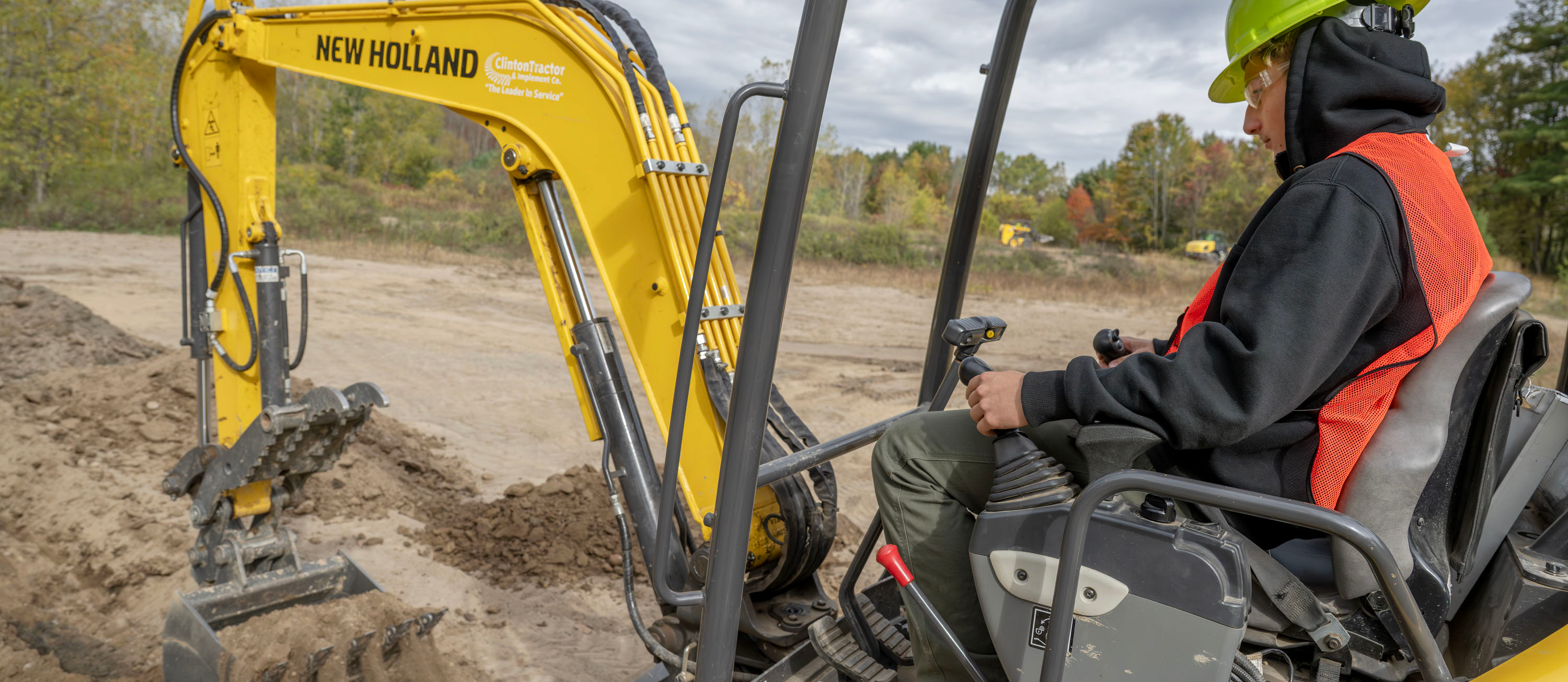 HERO student digging dirt with heavy equipment machinery