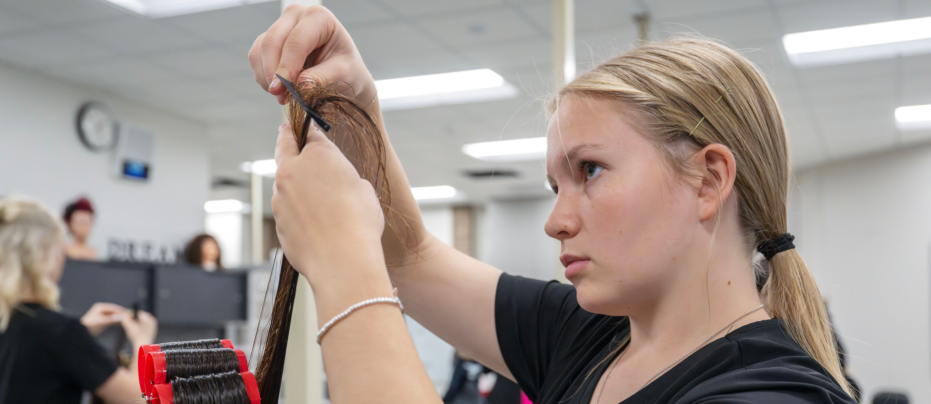Cosmetology student cutting hair