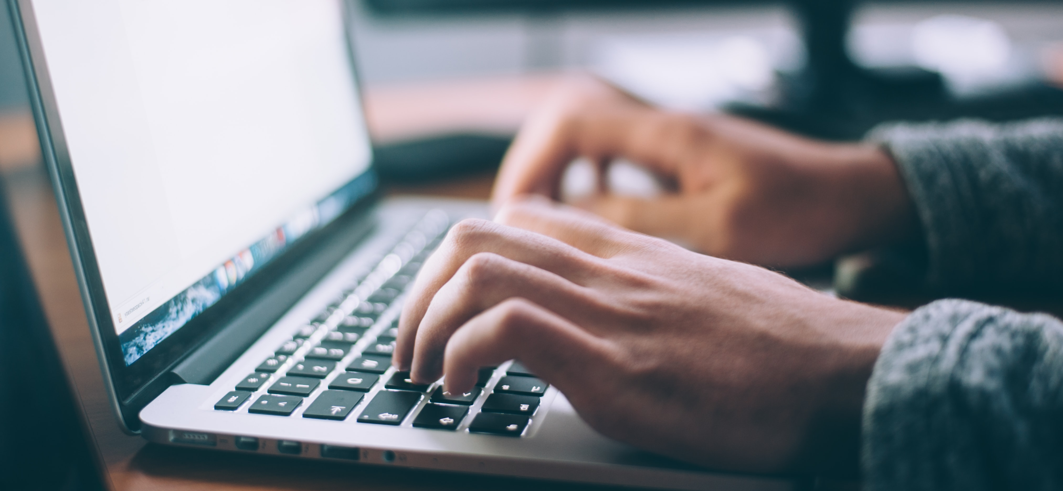 Laptop with hands typing