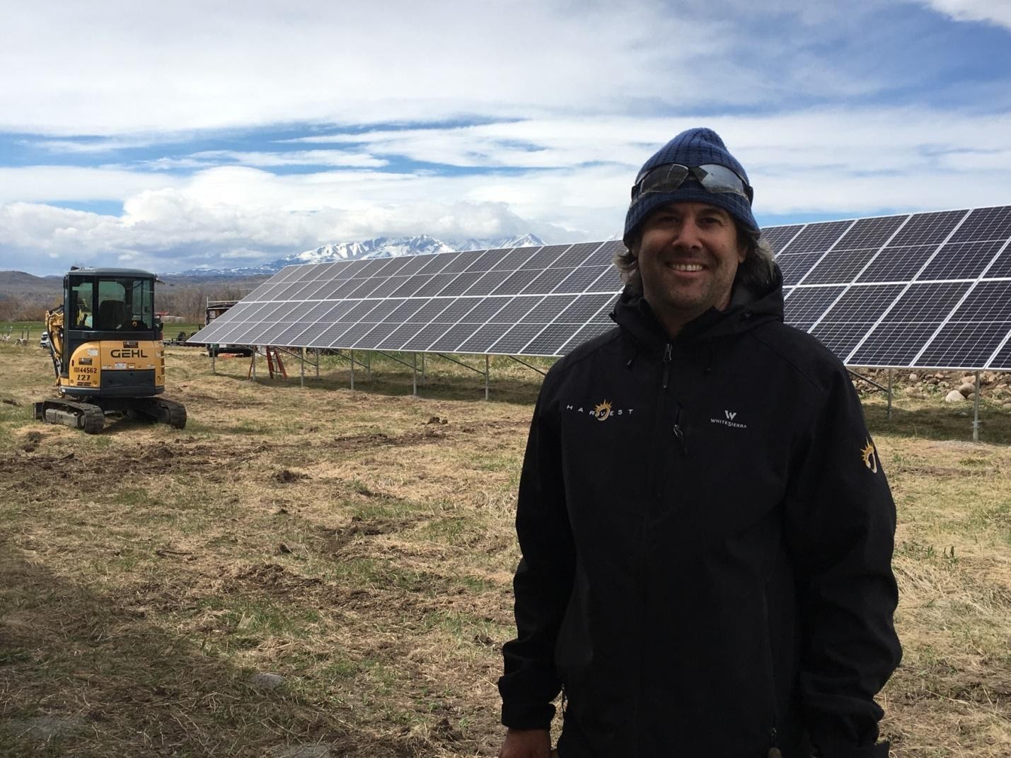 Person standing in front of solar panels