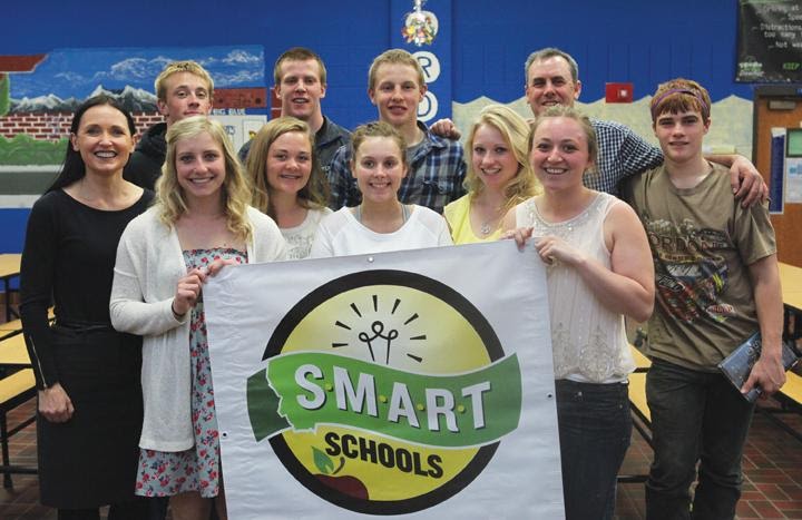 Group of people holding "Smart Schools" banner