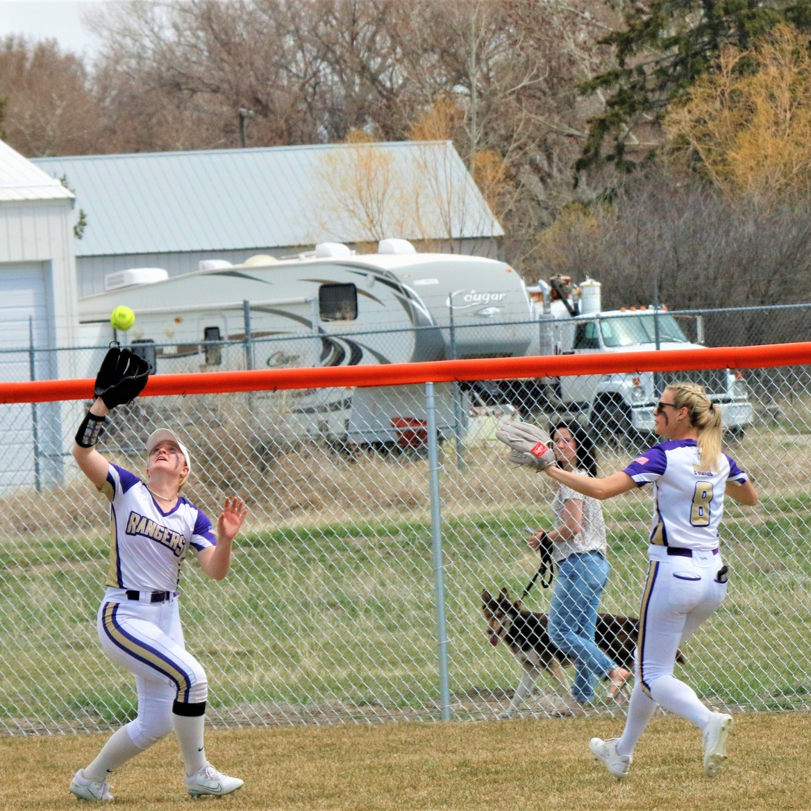 herder softball players run to catch a ball