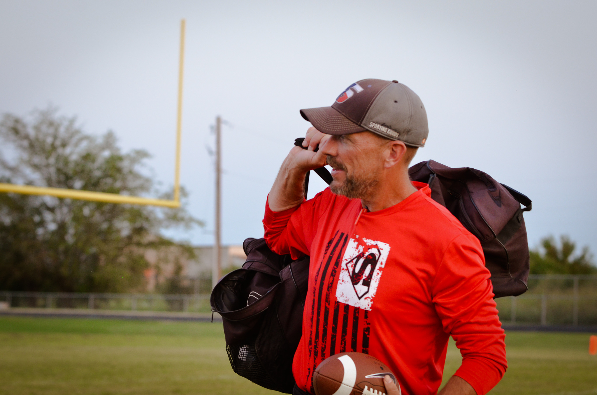 Coach Eli transports equipment before a JH Football game.