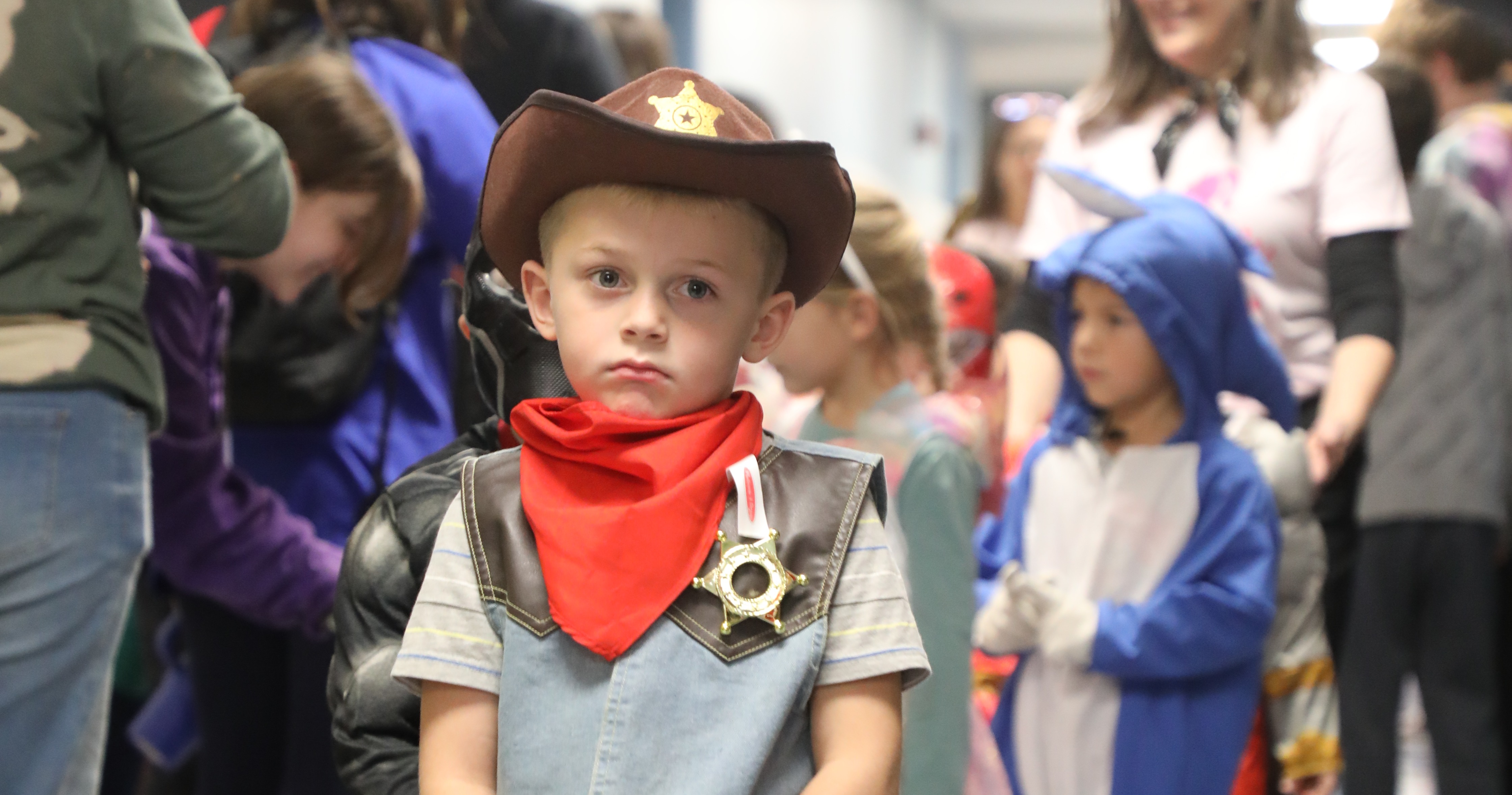 Student stands in a school hallway wearing a Halloween costume