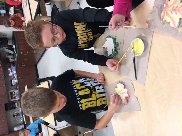 2nd graders glazing their ceramic leaf bowls