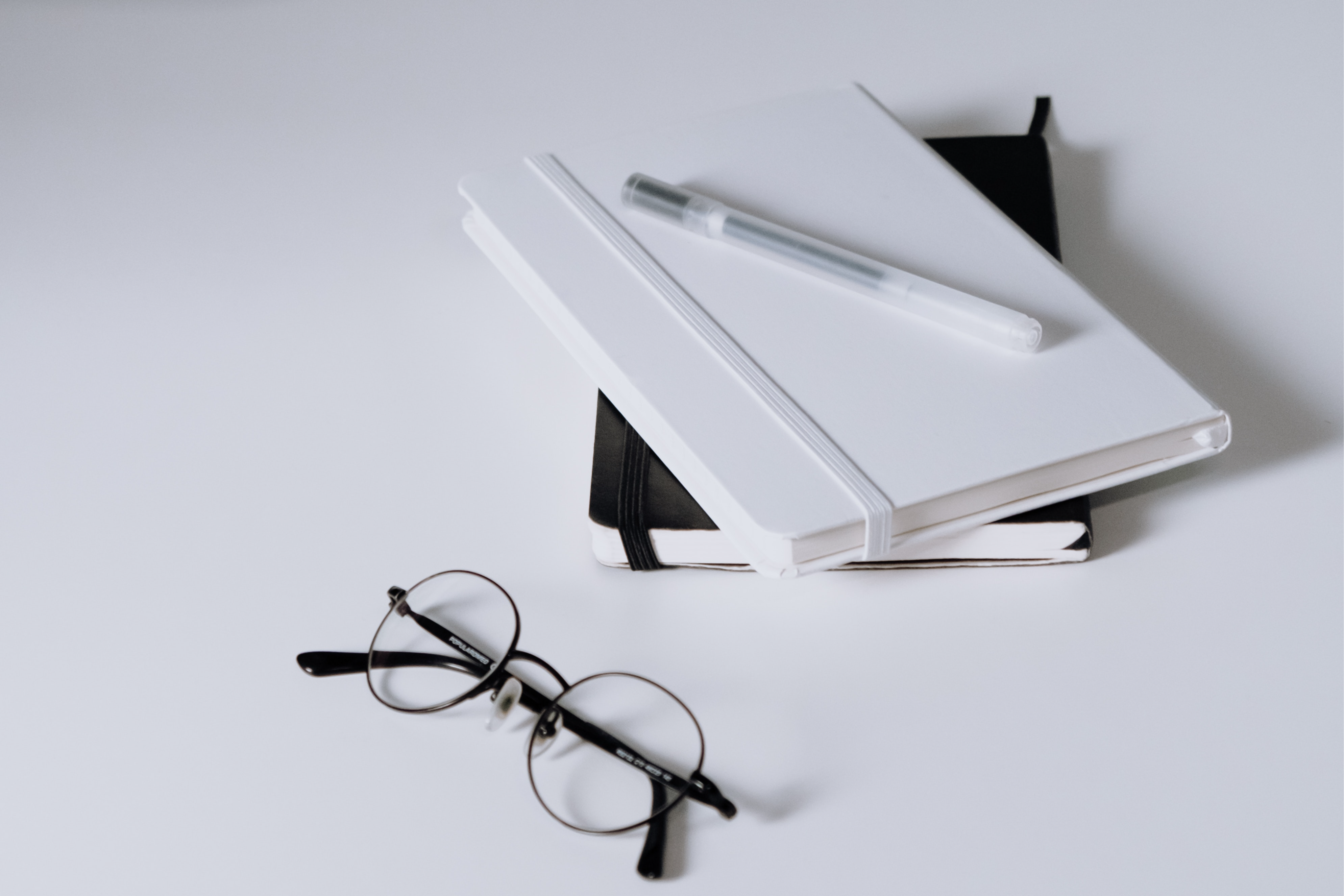 eye glasses and two notebooks
