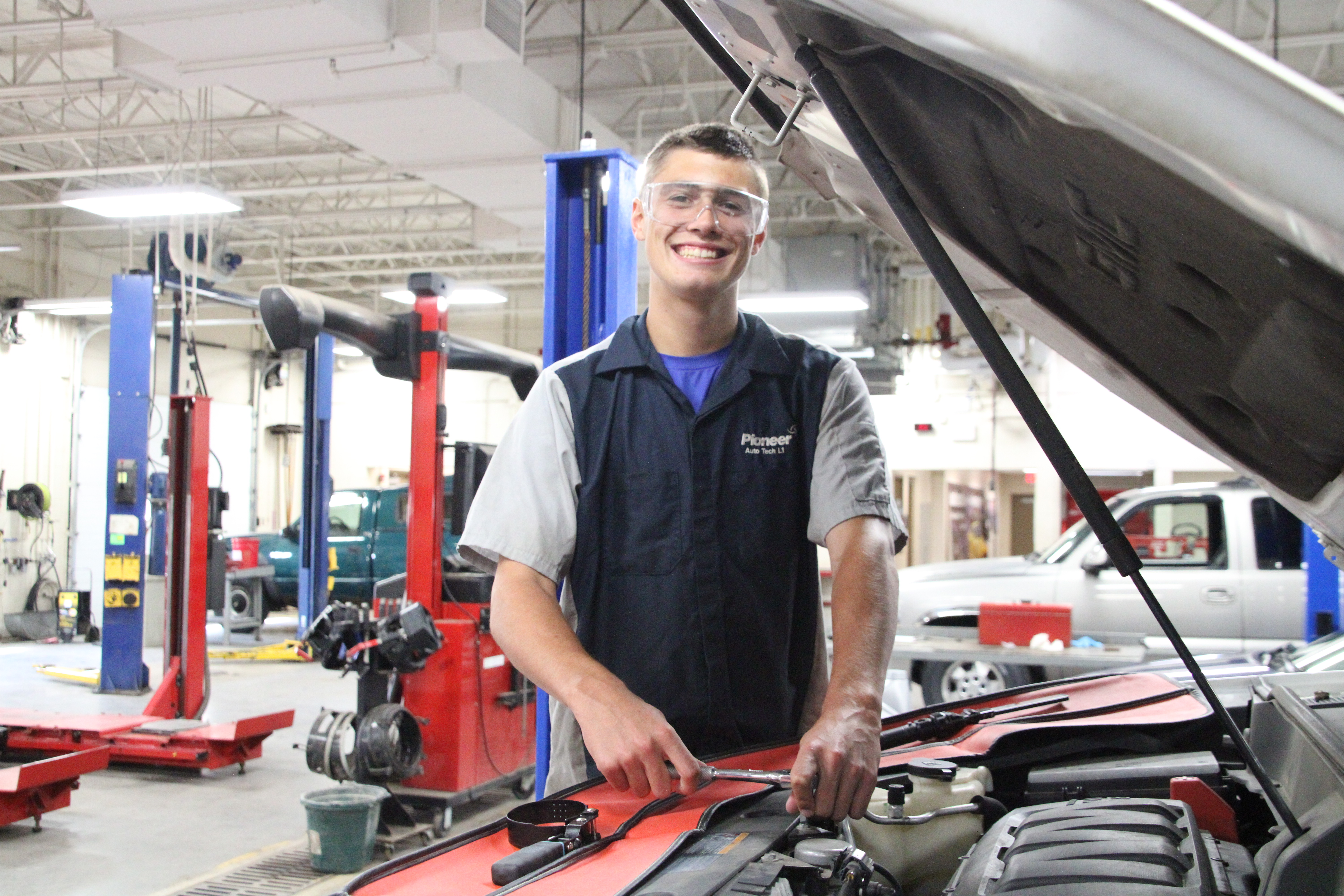 automotive technology student at work on a vehicle