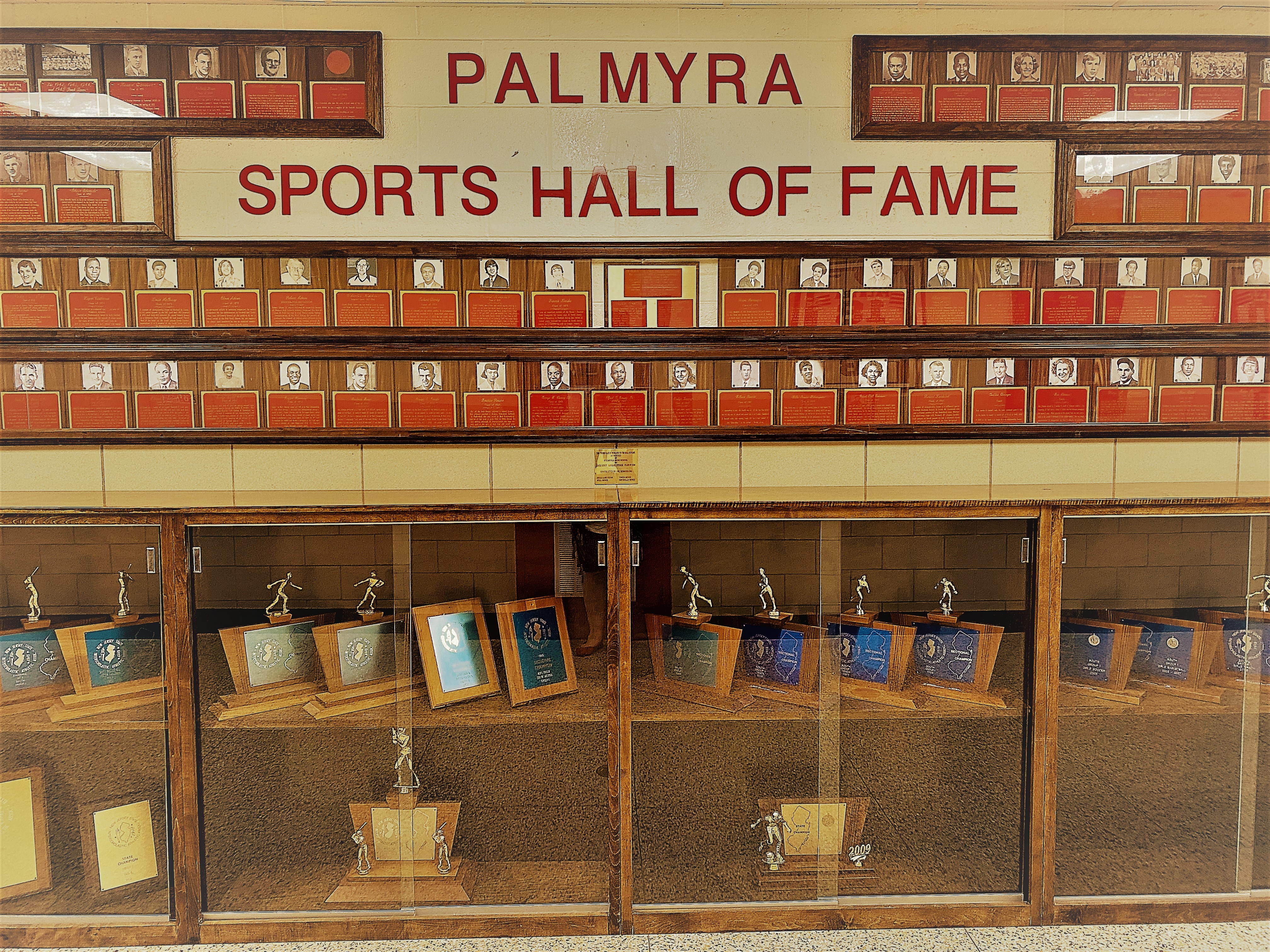 athletics hall of fame hallway with plaques & trophies