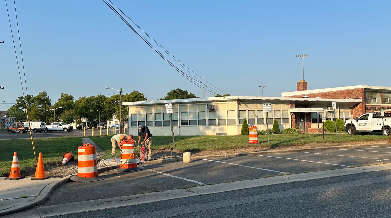 DAS sidewalks being replaced - 2 men with jackhammers excavating the old sidewalk