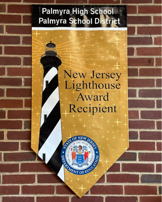 Banner on brick wall stating Palmyra High School winners of the NJ Lighthouse Award