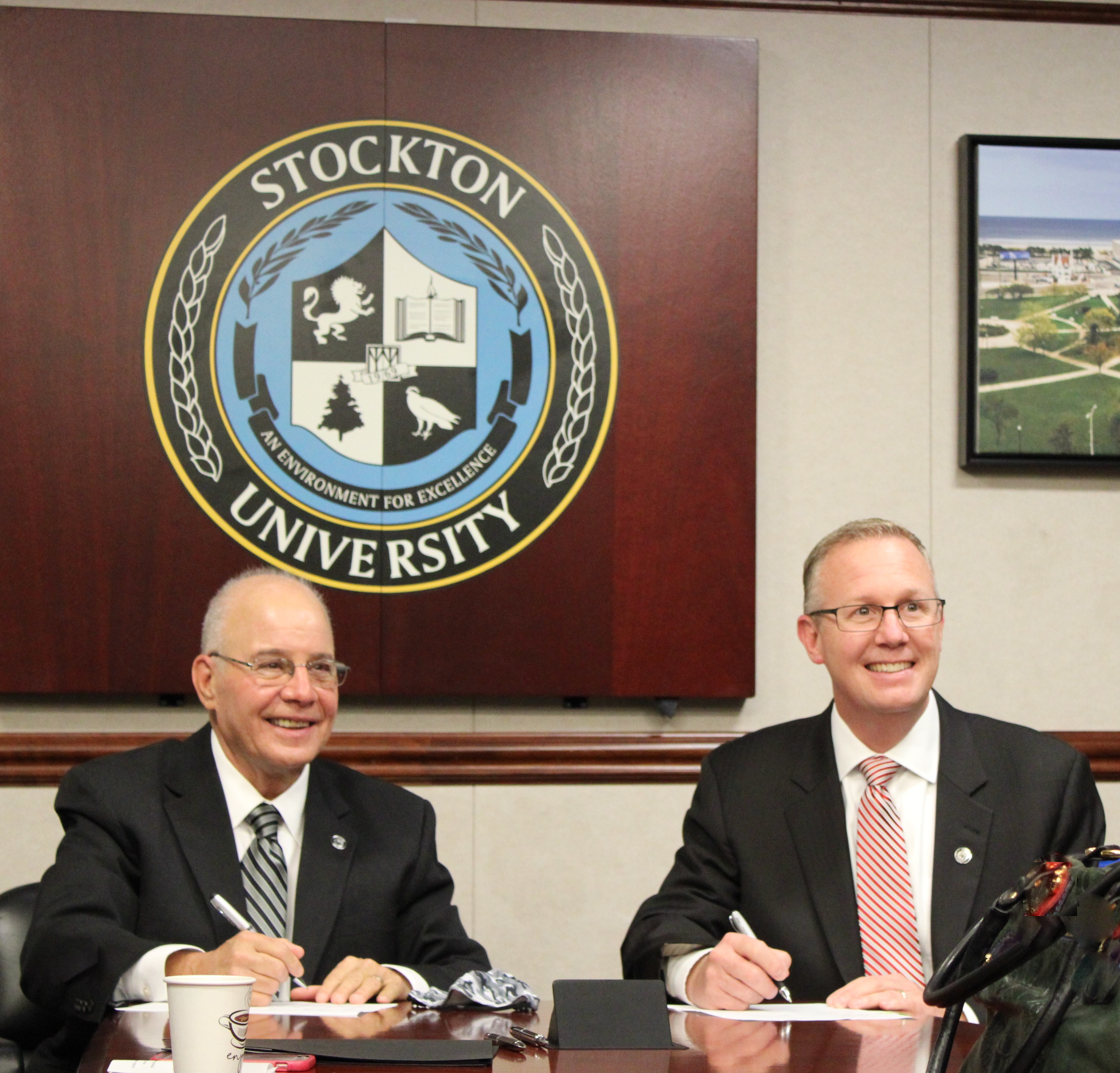 Dr. McBride signing the agreement with Stockton University for ECHS with university president, Dr. Kesselman