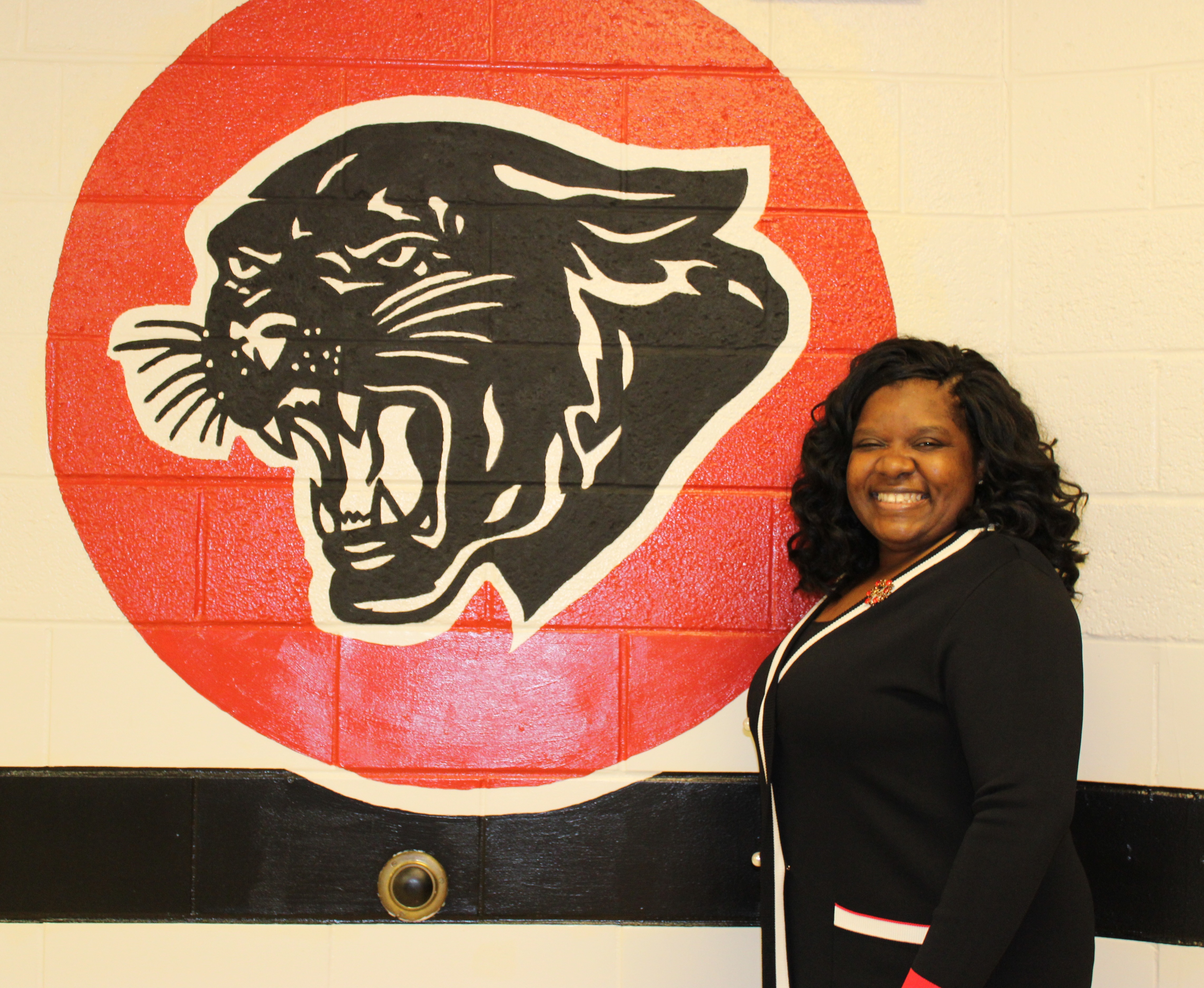 Principal Octavia Lee in front of the Panther Seal